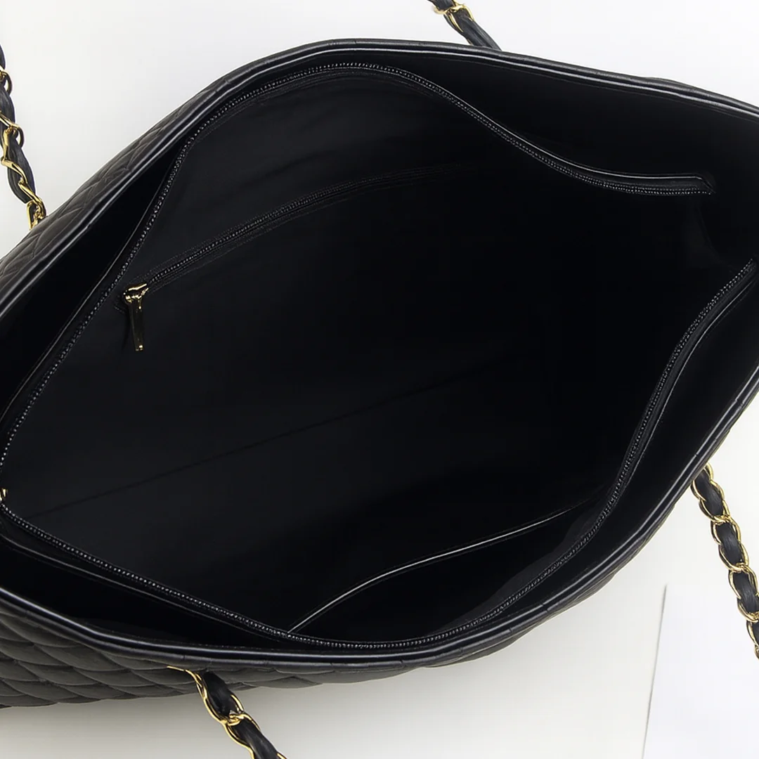 Interior of black quilted tote bag showing soft black fabric lining, zipper pocket and open pocket β Womenβs Tote Bags Pakistan β VibeTotes