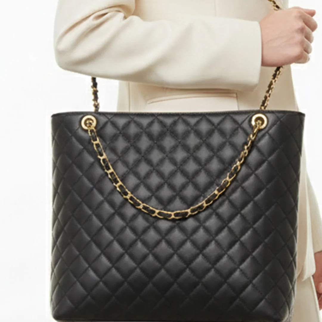 Woman carrying black quilted tote bag with gold chain straps β Stylish Ladies Bag for Daily Use in Pakistan β VibeTotesβ