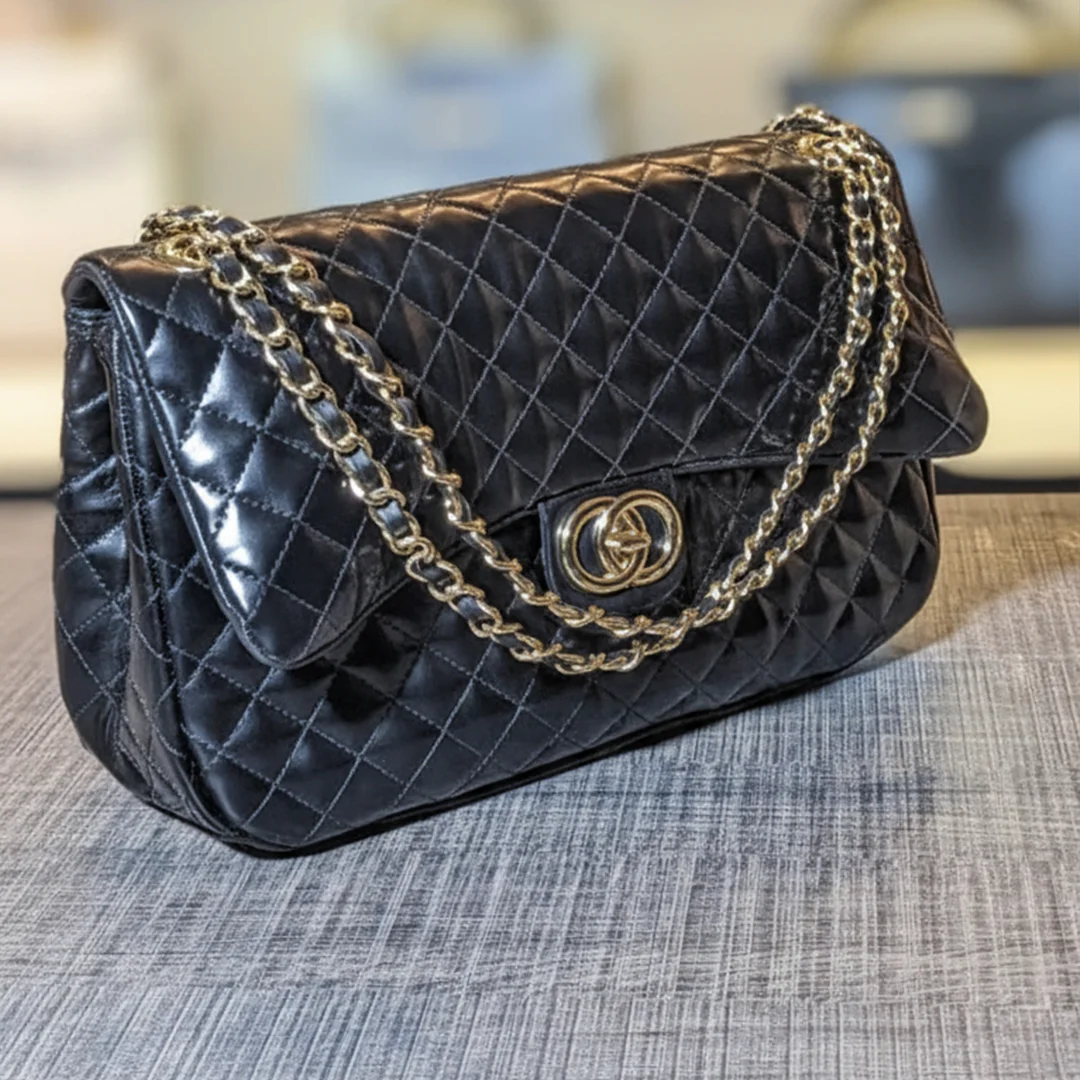 Black quilted ladies shoulder bag with gold chain – side view