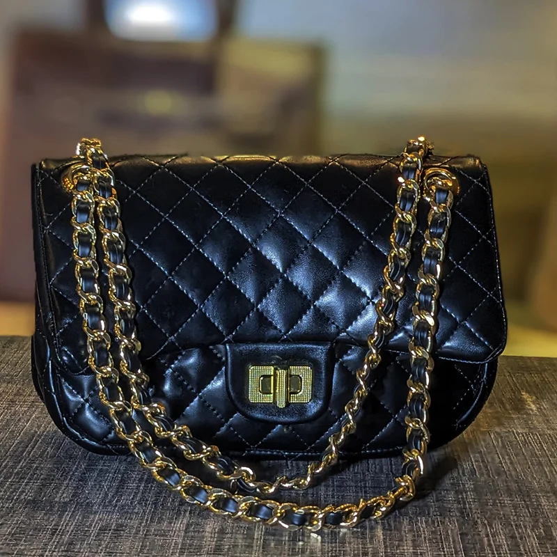 Front view of black quilted crossbody and shoulder bag with gold chain strap – Vibe Totes