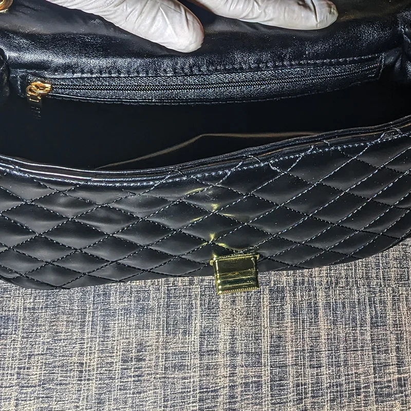 Inside view of black quilted ladies bag showing zipper pocket and open compartment – Vibe Totes