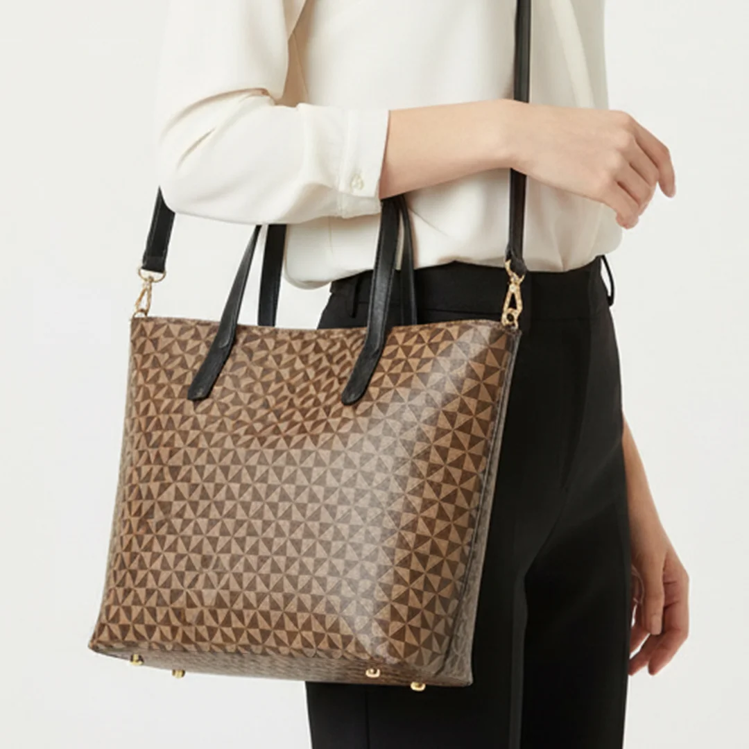 Woman carrying brown geometric ladies tote bag with shoulder strap