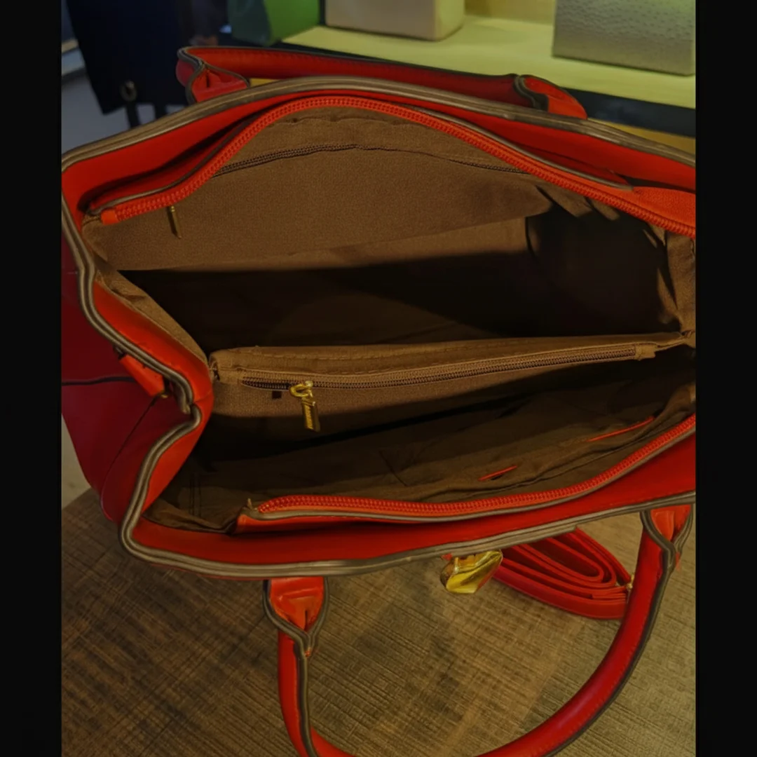 Inner view of red shoulder bag showing spacious compartments and zipper pocket – Vibe Totes