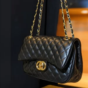Side angle of quilted black ladies crossbody bag with gold chain strap – Vibe Totes