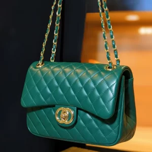Front view of dark green quilted crossbody bag with gold-tone double-ring clasp by Vibe Totes