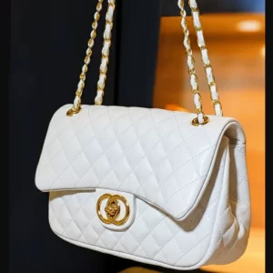 White quilted ladies crossbody bag with gold chain front view by Vibe Totes.