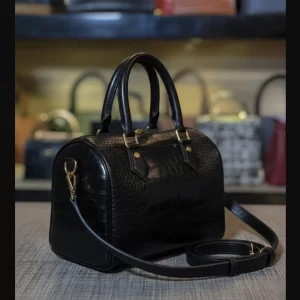 Side view of black crocodile texture ladies crossbody duffle bag by Vibe Totes