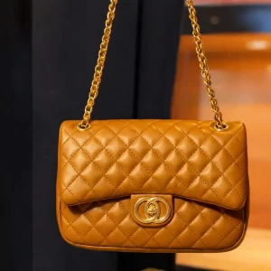 Front view of quilted mustard ladies crossbody bag with gold clasp and chain – Vibe Totes