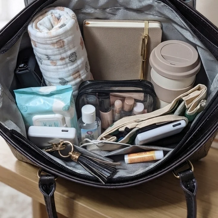Spacious interior organizer of Vibe Totes black crocodile leather handbag showing daily essentials and pockets