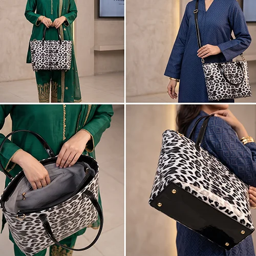 Model wearing Pakistani attire carrying the Vibe Totes white snow leopard tote bag by its black patent top handles.